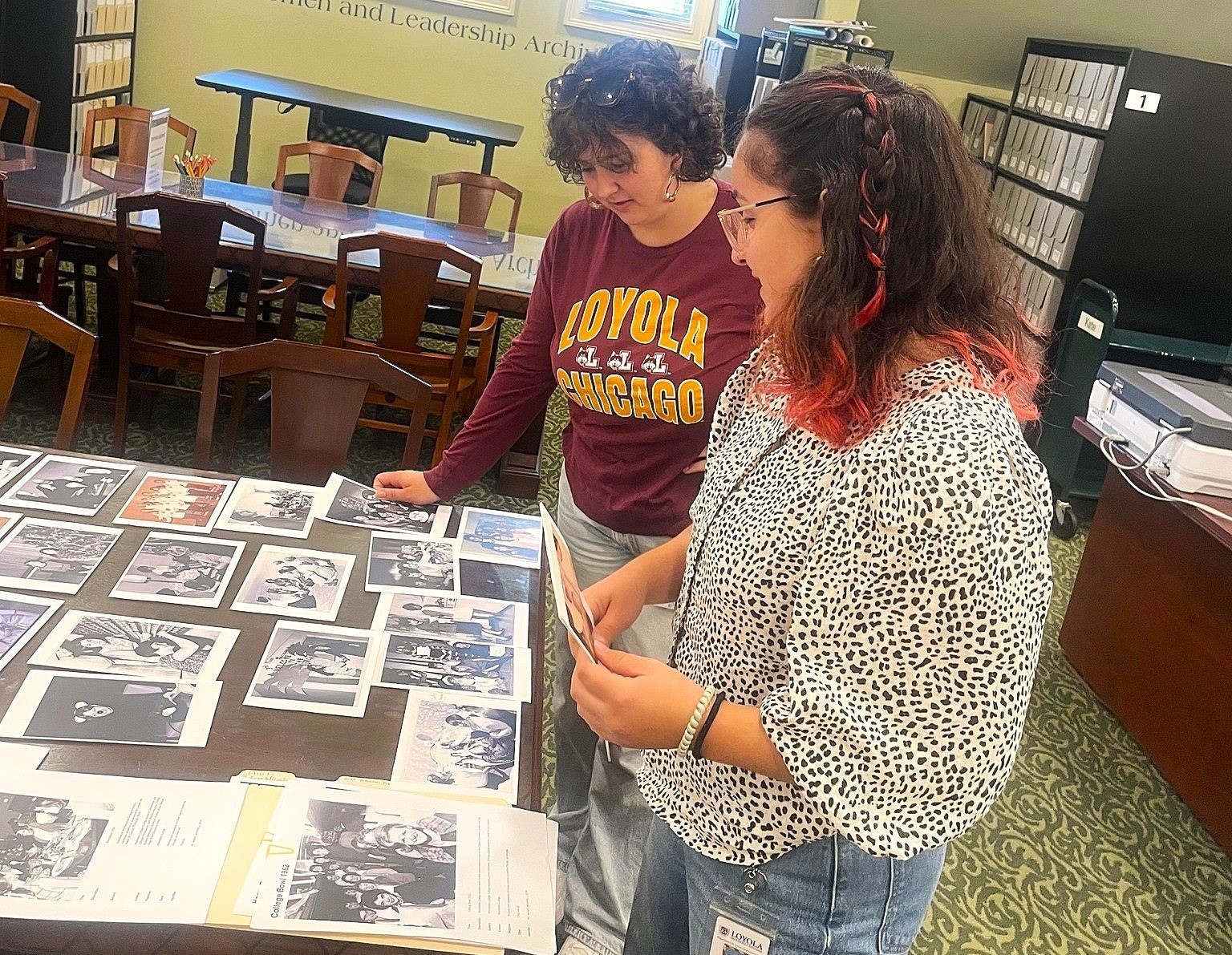 Graduate student workers looking at photos for a display